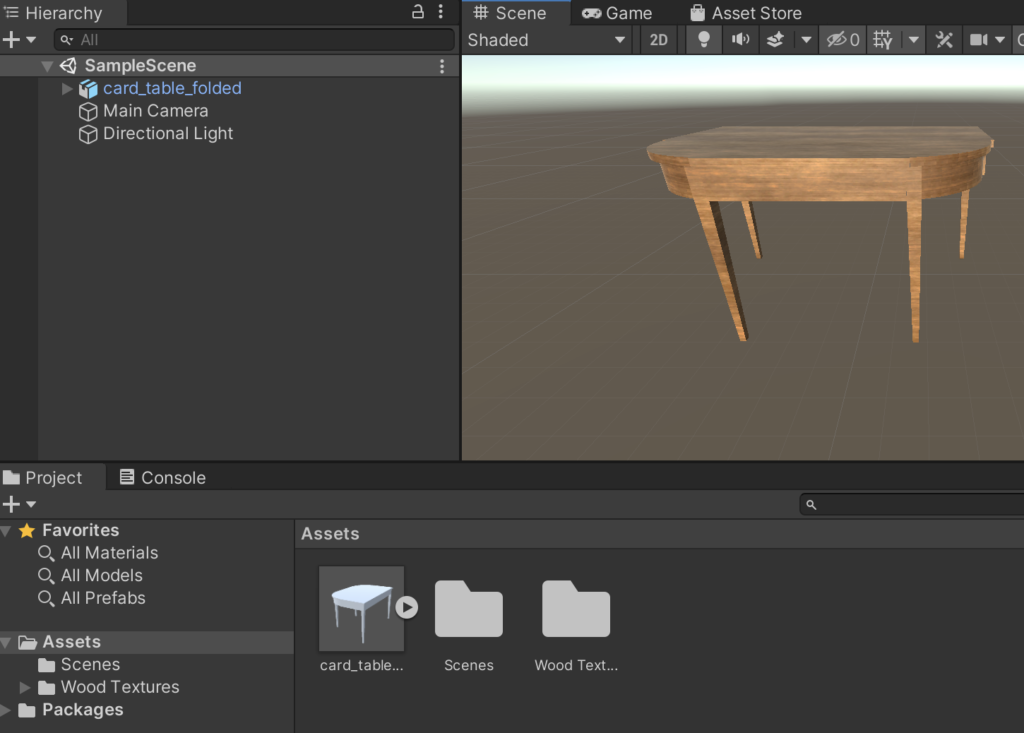 Unity interface depicting a federal-style card table. Left hand panel shows the object hierarchy. Bottom panel shows assets in the project. Right-hand side shows a model of a federal-style table with more robust wood textures applied.